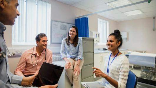 Four mental health care workers sitting in an office talking