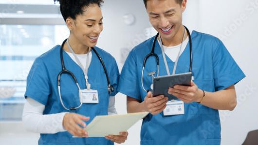 Two nurses walking down the hall talking together