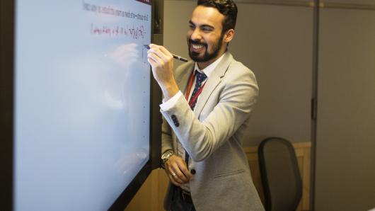 EXecutive Education participant writing on digital hub. 