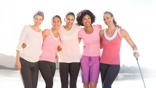 Women standing in a group smiling.