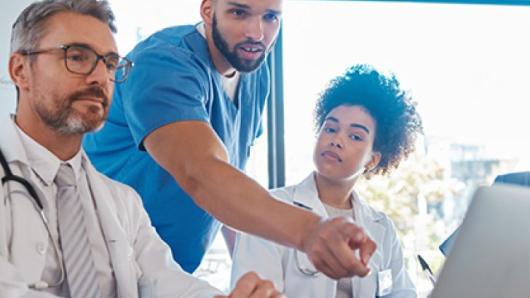 Health care providers looking at screens.