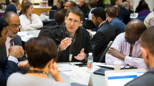 Health care leaders sitting at a table talking
