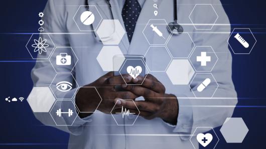 Physician in a lab coat in the background with computer and health care symbols superimposed