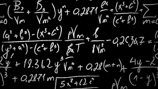 math equations written on a black chalkboard with white chalk