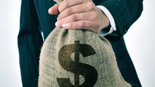 man holding a bag of money