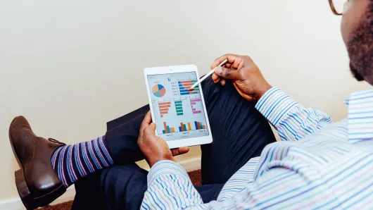 Man looking at data on tablet