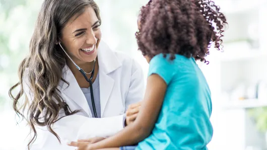 Pediatric doctor with child.