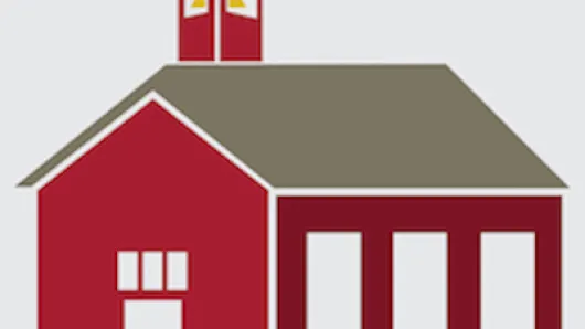 Red school house building with chapel-looking tower on top
