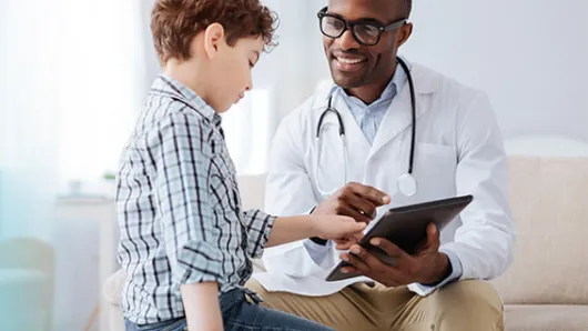 Pediatrician and child in office