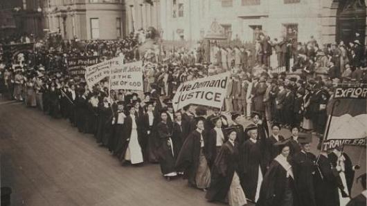 Women carrying signs in a protest march