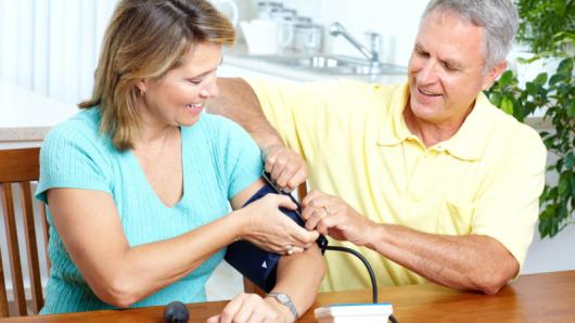 Adult couple checking blood pressure