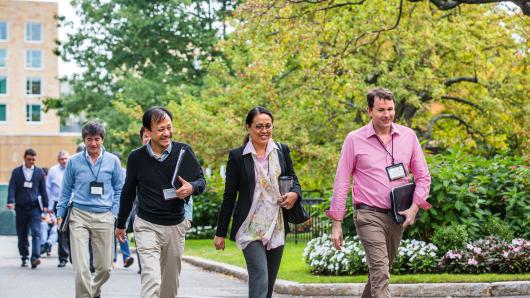 Diverse group of executives walking on the HBS campus