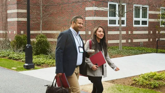 Executives walk to class on the HBS campus.