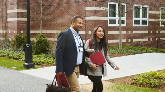 Executives walk to class on the HBS campus.