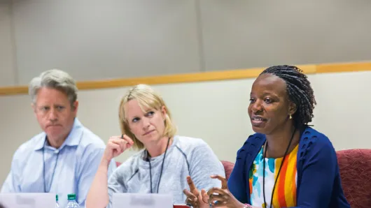 close up of a white male, a white female, and a black female executive in a classroom