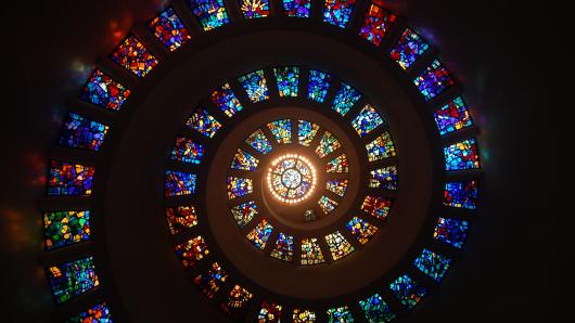 Stained glass windows arranged in a spiraling shape