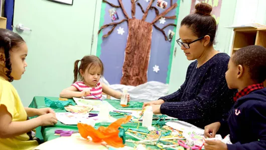Teacher leading an activity with students.