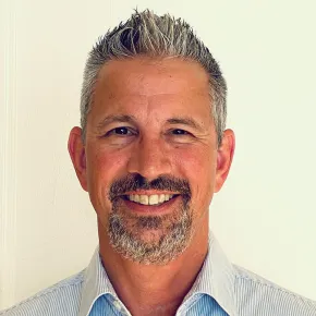 a white man with a goatee and greying hair