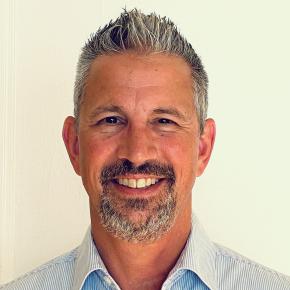 a white man with a goatee and greying hair