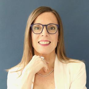 a white woman with glasses and shoulder length blonde hair