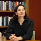 portrait of Hannah Riley Bowles in front of a bookshelf