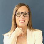 a white woman with glasses and shoulder length blonde hair