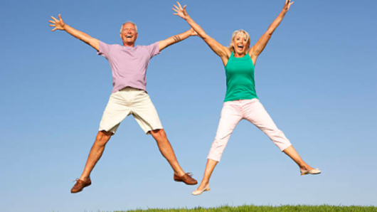 A man and woman jumping happily.