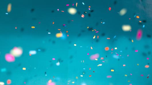Colorful confetti against a blue background