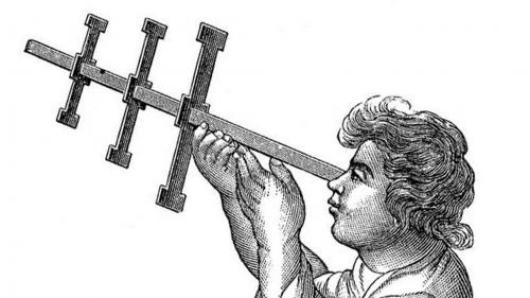 Person holding a Jacob's Staff, a device used to measure longitude.